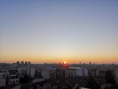 a sunset view of a city with buildings at Belgrade Panoramic View Large Terrace Free Parking in Belgrade