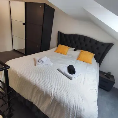 a bedroom with a bed with towels on it at Zeus Apartment in Rakovica