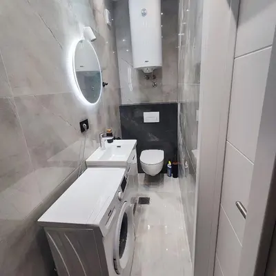 a white bathroom with a toilet and a sink at Zeus Apartment in Rakovica
