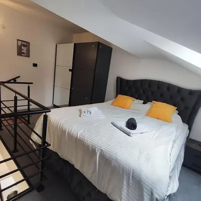 a bedroom with a large bed with a hat on it at Zeus Apartment in Rakovica