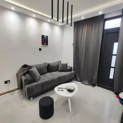 a living room with a couch and a table at Zeus Apartment in Rakovica