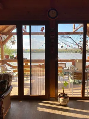 a room with sliding glass doors with a view of the ocean at Bird of Paradise in Belgrade