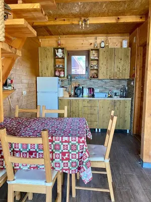 a kitchen and dining room with a table and chairs at Bird of Paradise in Belgrade