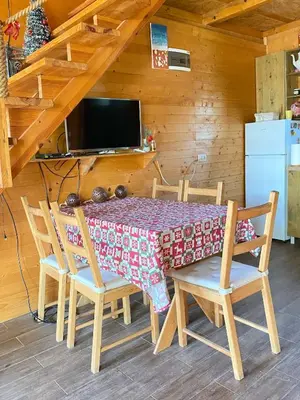 a dining room with a table and chairs in a cabin at Bird of Paradise in Belgrade
