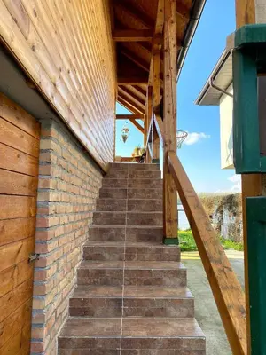 a staircase leading up to a building with a wooden roof at Bird of Paradise in Belgrade