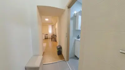 a hallway leading to a kitchen with a hallway leading to a house at Center Point apartment in Belgrade