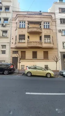 a yellow car parked in front of a building at Center Point apartment in Belgrade