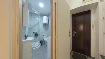 a small bathroom with a toilet and a sink at Center Point apartment in Belgrade