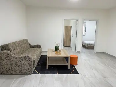 a living room with a couch and a table at Airport Art Villa in Čukarica