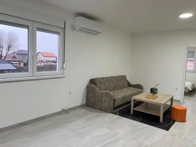 a living room with a couch and a table at Airport Art Villa in Čukarica