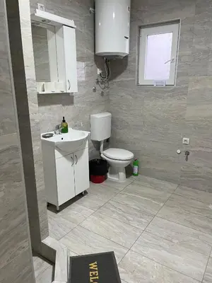 a bathroom with a white sink and a toilet at Airport Art Villa in Čukarica
