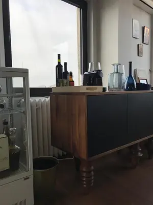 a wooden table in a room with a radiator at Exceptional City Center River View Apartment in Belgrade
