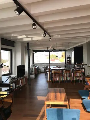 a room with tables and chairs and a dining room at Exceptional City Center River View Apartment in Belgrade