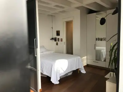 a bedroom with a white bed in a room at Exceptional City Center River View Apartment in Belgrade