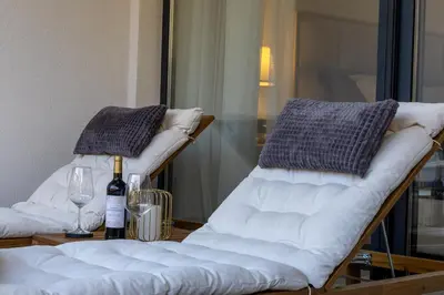 a table with two chairs and a bottle of wine at Deluxe Kosmaj Residence in Rogača