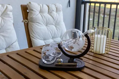 a glass globe on a table with two glasses at Deluxe Kosmaj Residence in Rogača