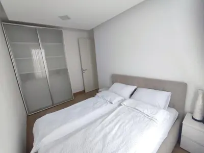a bedroom with a bed with white sheets and pillows at Premium Belvil apartment, free parking in Belgrade