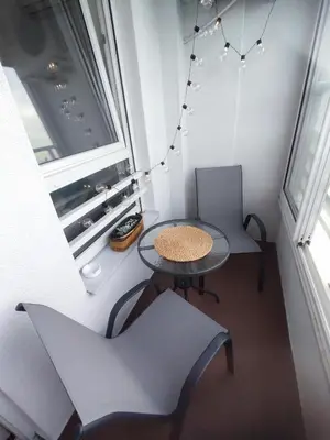 a small table and two chairs in a room with a window at Premium Belvil apartment, free parking in Belgrade