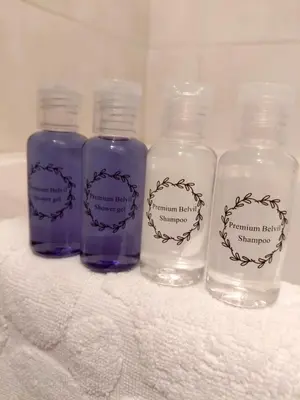 four bottles with labels on them sitting on a towel at Premium Belvil apartment, free parking in Belgrade