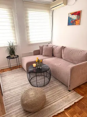 a living room with a couch and a table at Ada Zen in Belgrade