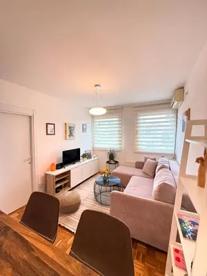 a living room with a couch and a tv at Ada Zen in Belgrade