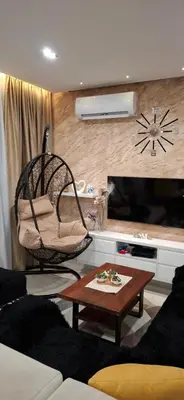a living room with a chair and a table at Apartman Laki-M in Belgrade
