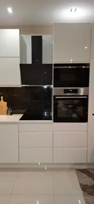 a kitchen with white cabinets and an oven at Apartman Laki-M in Belgrade
