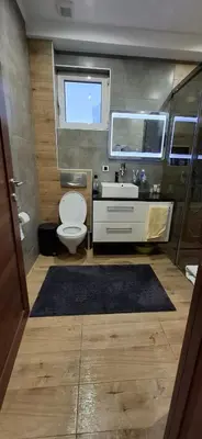 a bathroom with a toilet and a sink and a mirror at Apartman Laki-M in Belgrade