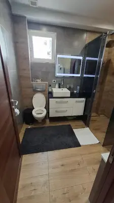 a small bathroom with a toilet and a sink at Apartman Laki-M in Belgrade