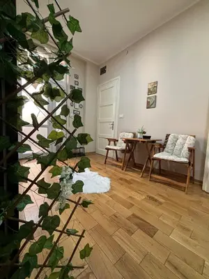 a living room with a table and a plant at Apartment Dana in Belgrade