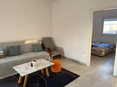 a living room with a couch and a table at Airport Art Villa in Ćosine Kolibe