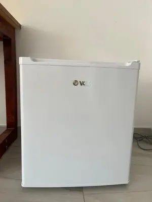 a white refrigerator sitting on the floor in a room at Airport Art Villa in Ćosine Kolibe