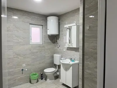 a bathroom with a toilet and a sink at Airport Art Villa in Ćosine Kolibe