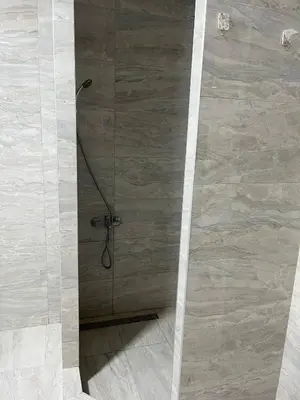a shower in a bathroom with a glass door at Airport Art Villa in Ćosine Kolibe