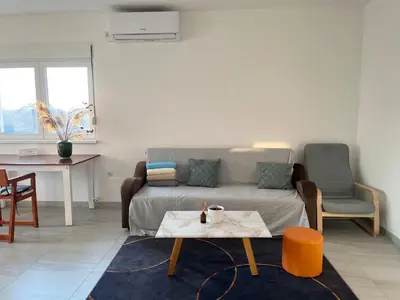 a living room with a couch and a table at Airport Art Villa in Ćosine Kolibe