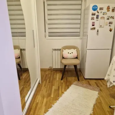 a kitchen with a chair with a hello kitty pillow on it at Stylish and cozy stay in Belgrade