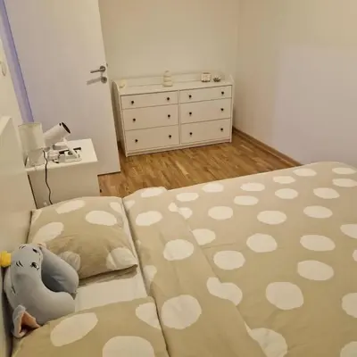 a bedroom with a bed with a stuffed elephant on it at Stylish and cozy stay in Belgrade