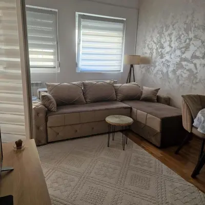 a living room with a couch and a table at Stylish and cozy stay in Belgrade