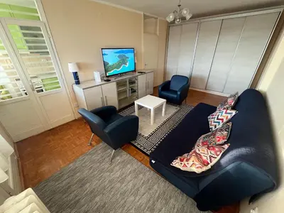 a living room with a couch and a tv at Comfort & Style Panoramic Urban Retreat 2 in Belgrade