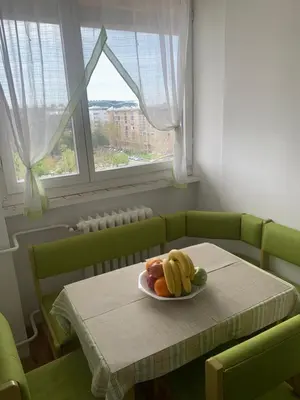 a plate of fruit on a table with a window at Comfort & Style Panoramic Urban Retreat 2 in Belgrade