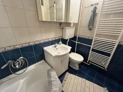 a bathroom with a toilet and a sink and a tub at Comfort & Style Panoramic Urban Retreat 2 in Belgrade