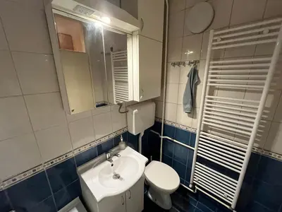 a bathroom with a toilet and a sink and a mirror at Comfort & Style Panoramic Urban Retreat 2 in Belgrade