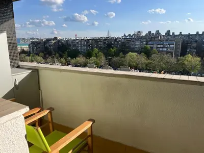 a balcony with a bench and a view of a city at Comfort & Style Panoramic Urban Retreat 2 in Belgrade