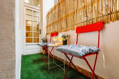 a room with two red chairs and a table with green carpet at Inspiration Source with Balcony Old Town in Belgrade