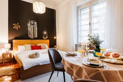 a bedroom with a bed and a table with food on it at Inspiration Source with Balcony Old Town in Belgrade