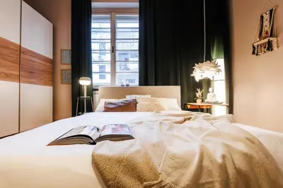 a bedroom with a bed with two books on it at Inspiration Source with Balcony Old Town in Belgrade