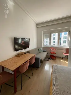 a living room with a couch and a table at Hilton View Cozy Njegoseva Vracar Apartment - Sleeps 4 in Belgrade