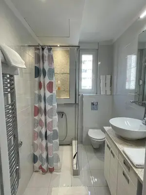 a bathroom with a sink and a toilet and a shower at Hilton View Cozy Njegoseva Vracar Apartment - Sleeps 4 in Belgrade