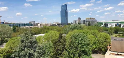 a city skyline with a tall building in the background at Apartman Fox in Belgrade