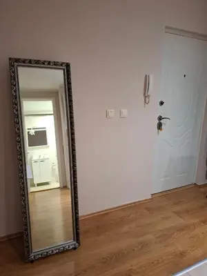 a mirror in a room next to a door at Sorelle in Belgrade